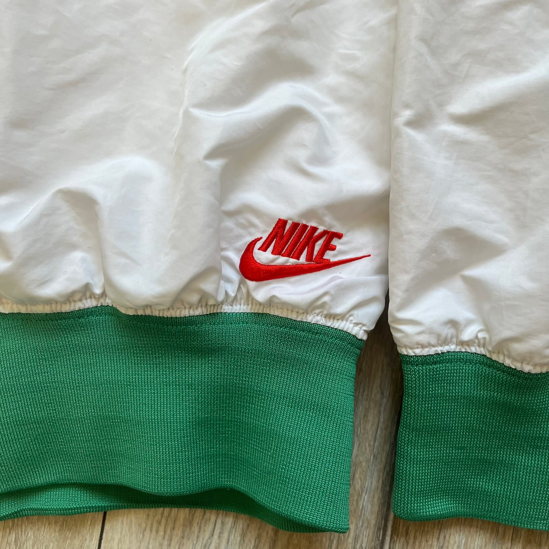 Nike Mexico Olympics Split Windbreaker from 2008, created by designer Jarrett Reynolds. Crafted in green/white/red, with a white lower half, red upper half and green hems/shoulders. Small Nike red embroidery finishes the jacket design. This innovative jacket can be zipped apart on both sides and merged with other compatible models.