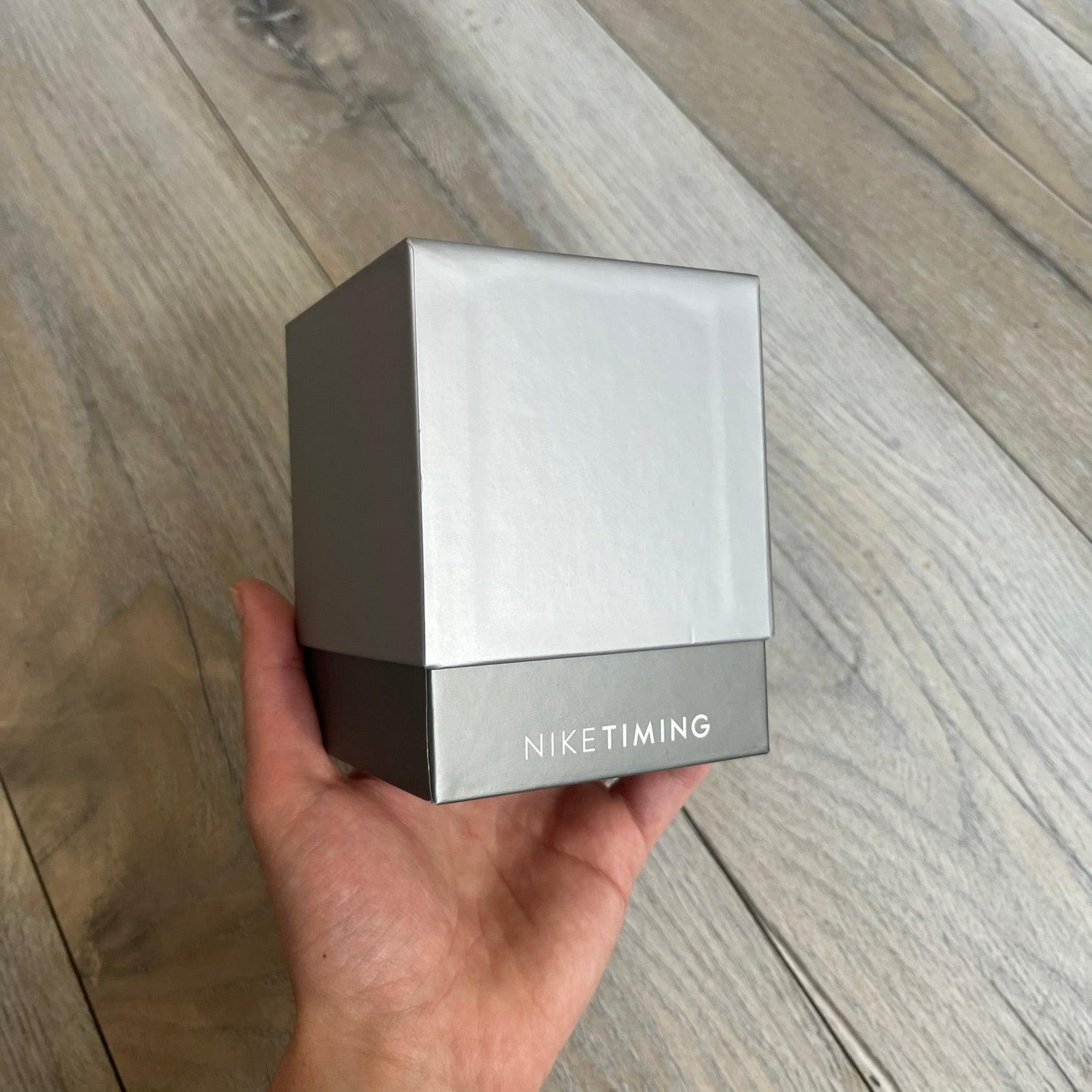 Nike Oregon Series Gray Digital Watch WA0036-441 is a digital wristwatch featuring a rectangular display with a stainless steel frame and a dark grey rubber strap with stainless steel clasp. The watch includes four side buttons, backlight function, and displays black digital numerals, with a small Nike logo on the metal bezel. It is water resistant up to 100 meters, powered by fresh batteries, and comes with original tag and box.