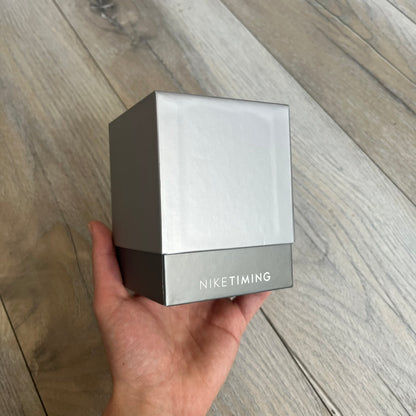 Nike Oregon Series Gray Digital Watch WA0036-441 is a digital wristwatch featuring a rectangular display with a stainless steel frame and a dark grey rubber strap with stainless steel clasp. The watch includes four side buttons, backlight function, and displays black digital numerals, with a small Nike logo on the metal bezel. It is water resistant up to 100 meters, powered by fresh batteries, and comes with original tag and box.