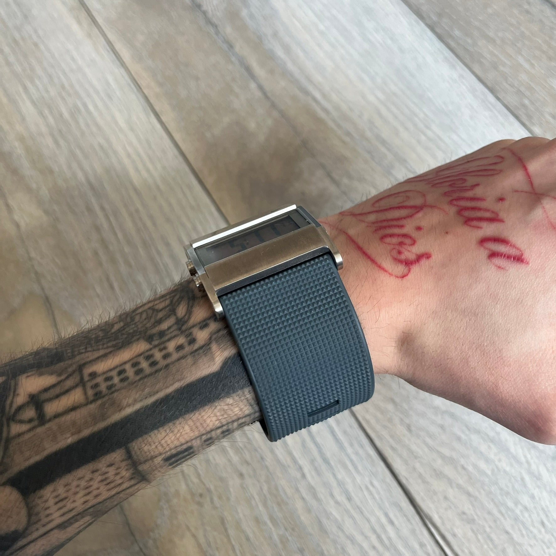 Nike Oregon Series Gray Digital Watch is a digital wristwatch featuring a rectangular display with a stainless steel frame and a dark grey rubber strap with stainless steel clasp. The watch includes four side buttons, backlight function, and displays black digital numerals, with a small Nike logo on the metal bezel. It is water resistant up to 100 meters, powered by fresh batteries, and comes with original tag and box.