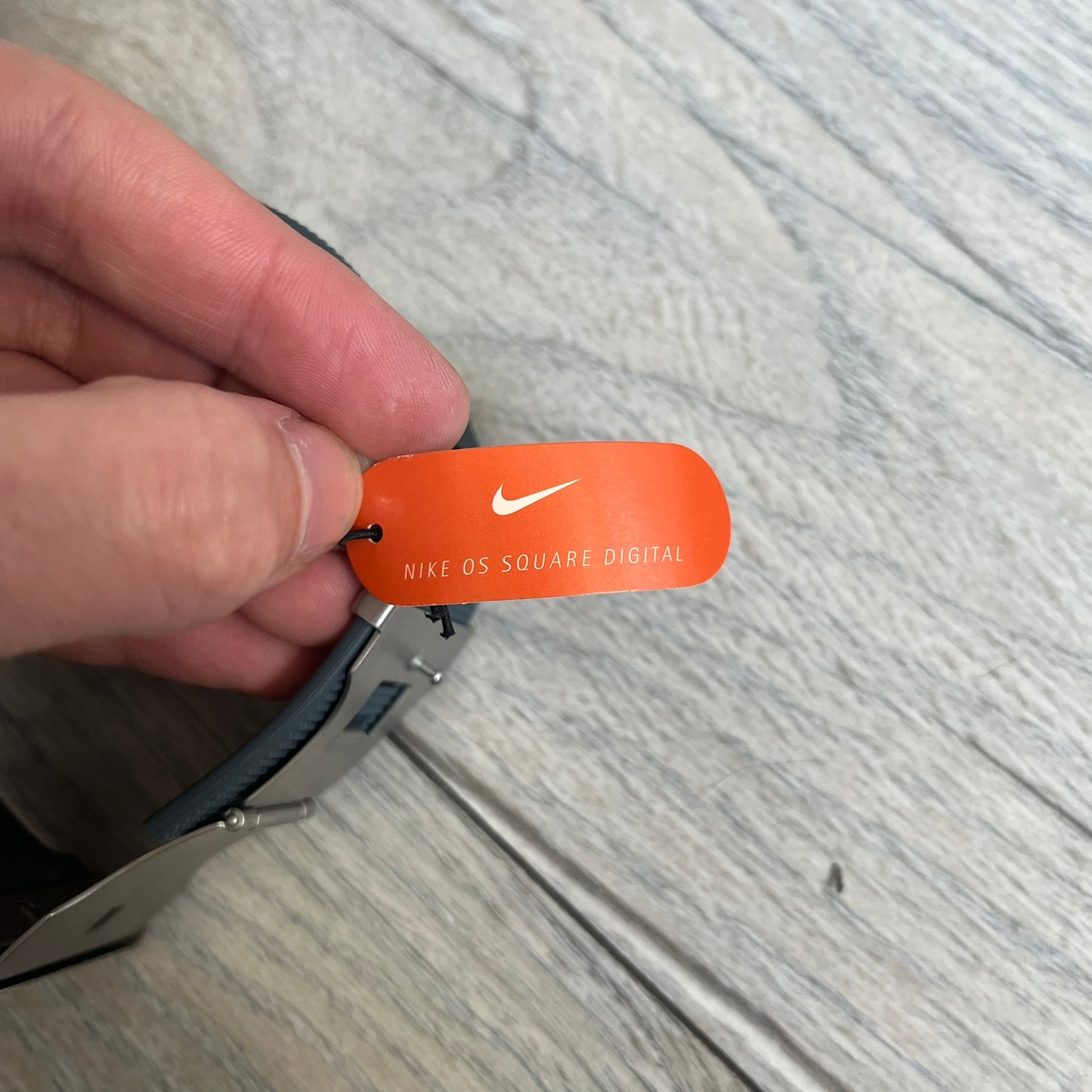 Nike Oregon Series Gray Digital Watch WA0036-441 is a digital wristwatch featuring a rectangular display with a stainless steel frame and a dark grey rubber strap with stainless steel clasp. The watch includes four side buttons, backlight function, and displays black digital numerals, with a small Nike logo on the metal bezel. It is water resistant up to 100 meters, powered by fresh batteries, and comes with original tag and box.