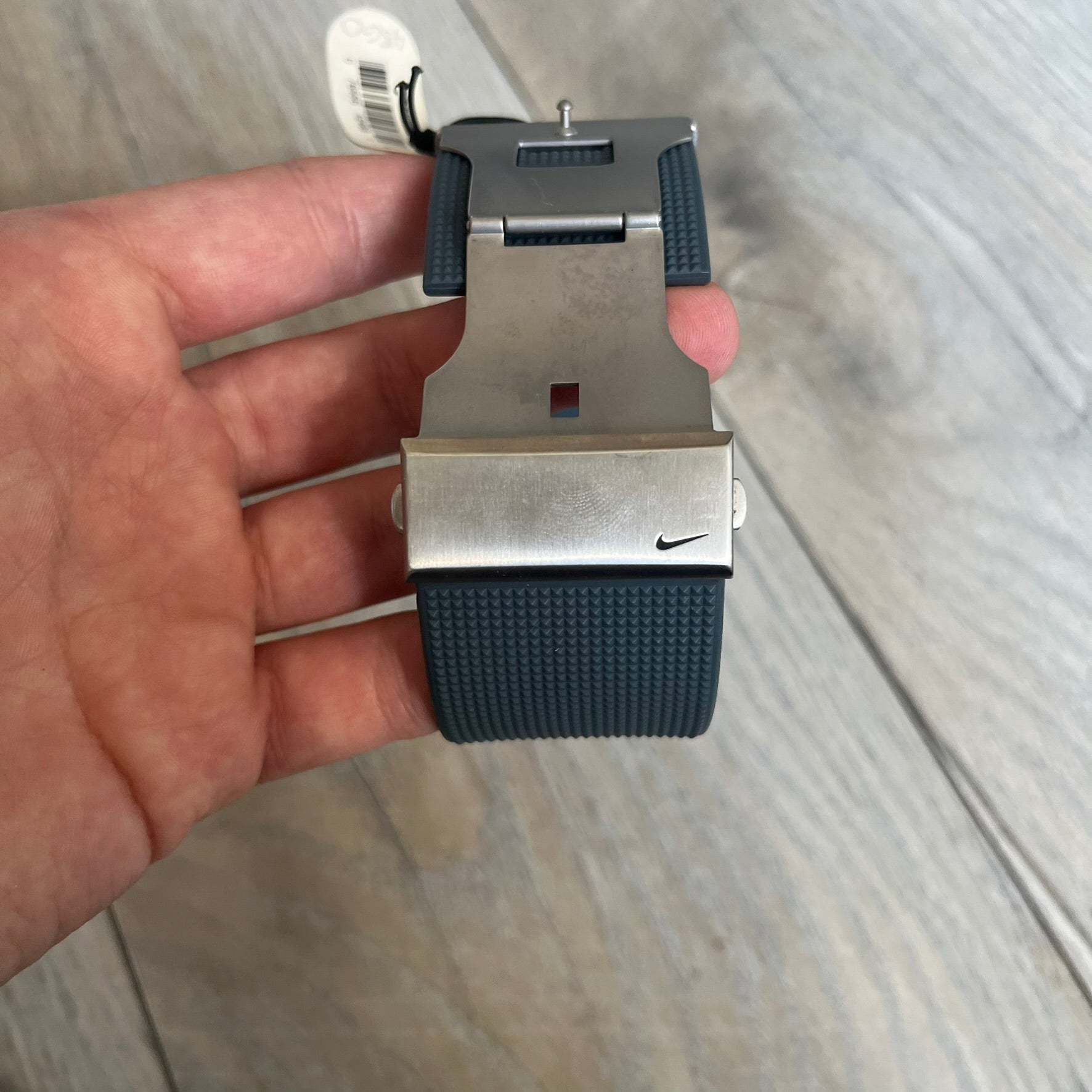 Nike Oregon Series Gray Digital Watch WA0036-441 is a digital wristwatch featuring a rectangular display with a stainless steel frame and a dark grey rubber strap with stainless steel clasp. The watch includes four side buttons, backlight function, and displays black digital numerals, with a small Nike logo on the metal bezel. It is water resistant up to 100 meters, powered by fresh batteries, and comes with original tag and box.