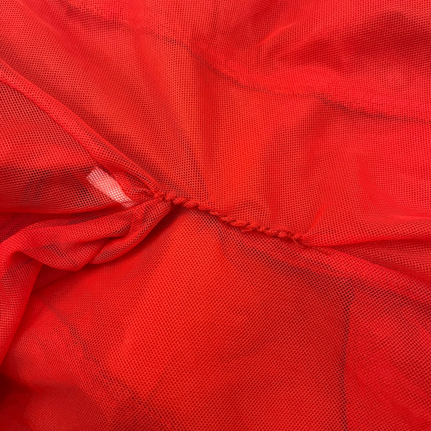 Nike Red/Blue/White Split Windbreaker featuring a modular design with front and back zippers that allow attachment to compatible jackets. The layout includes dominant red panels across the sleeves and upper front, contrasted with blue accents, a white hood, and a blue-white-black camo hood lining. Finished with a gold embroidered Nike logo on the chest.