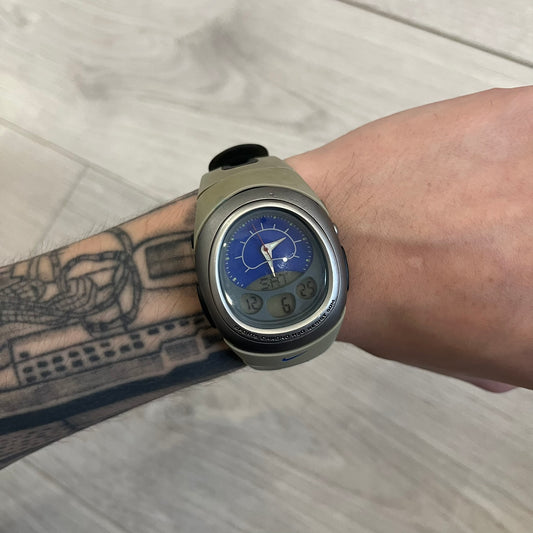 Nike Sports Chrono Cross Training Watch featuring a unique ana-digi design with a Blue Analog face. The display combines a three-hand analog setup with a curved dual-section LCD showing time, day, and mode. Water-resistant up to 50m and equipped with chronograph, timer, alarm, and dual-time functions.