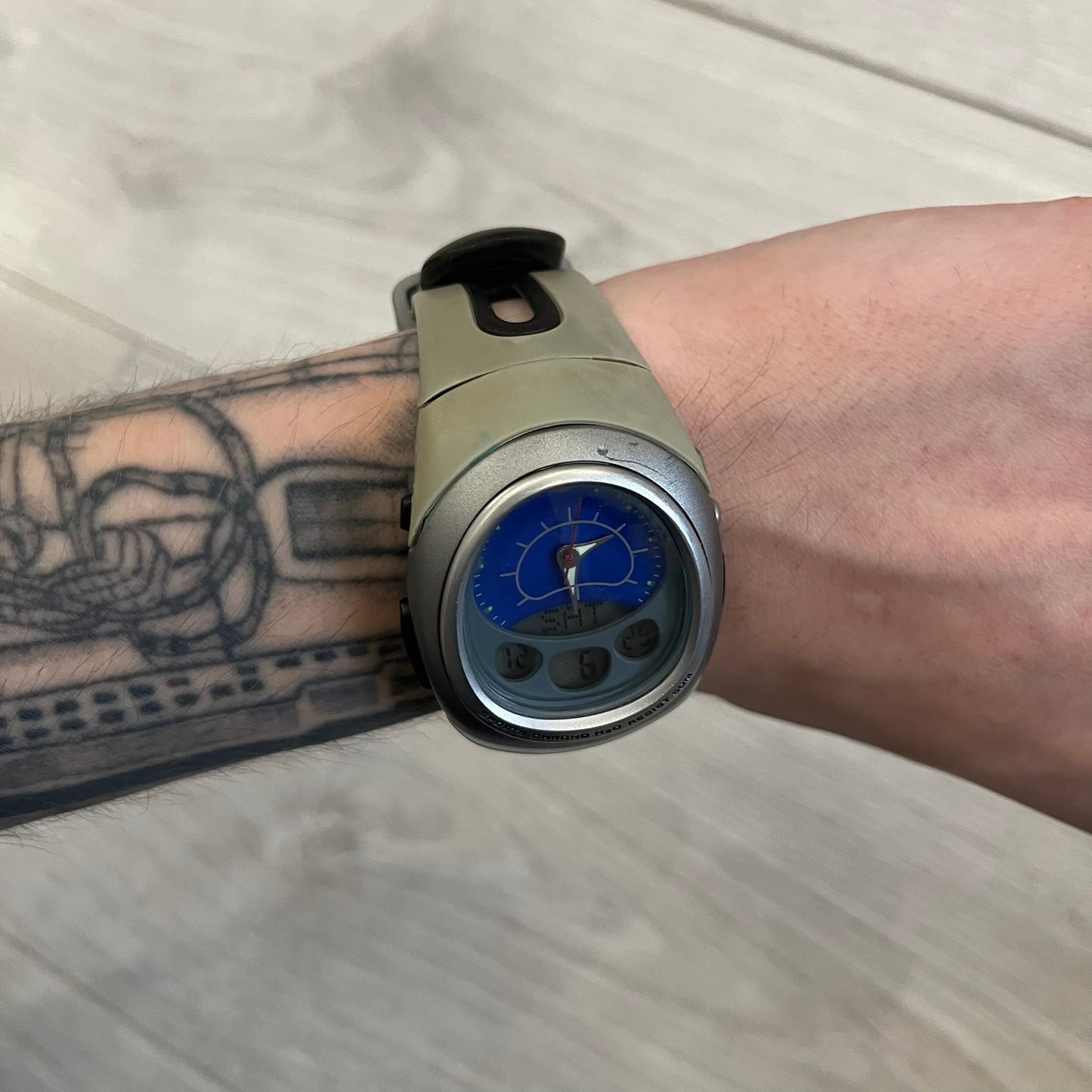 Nike Sports Chrono Cross Training Watch featuring a unique ana-digi design with a Blue Analog face. The display combines a three-hand analog setup with a curved dual-section LCD showing time, day, and mode. Water-resistant up to 50m and equipped with chronograph, timer, alarm, and dual-time functions.