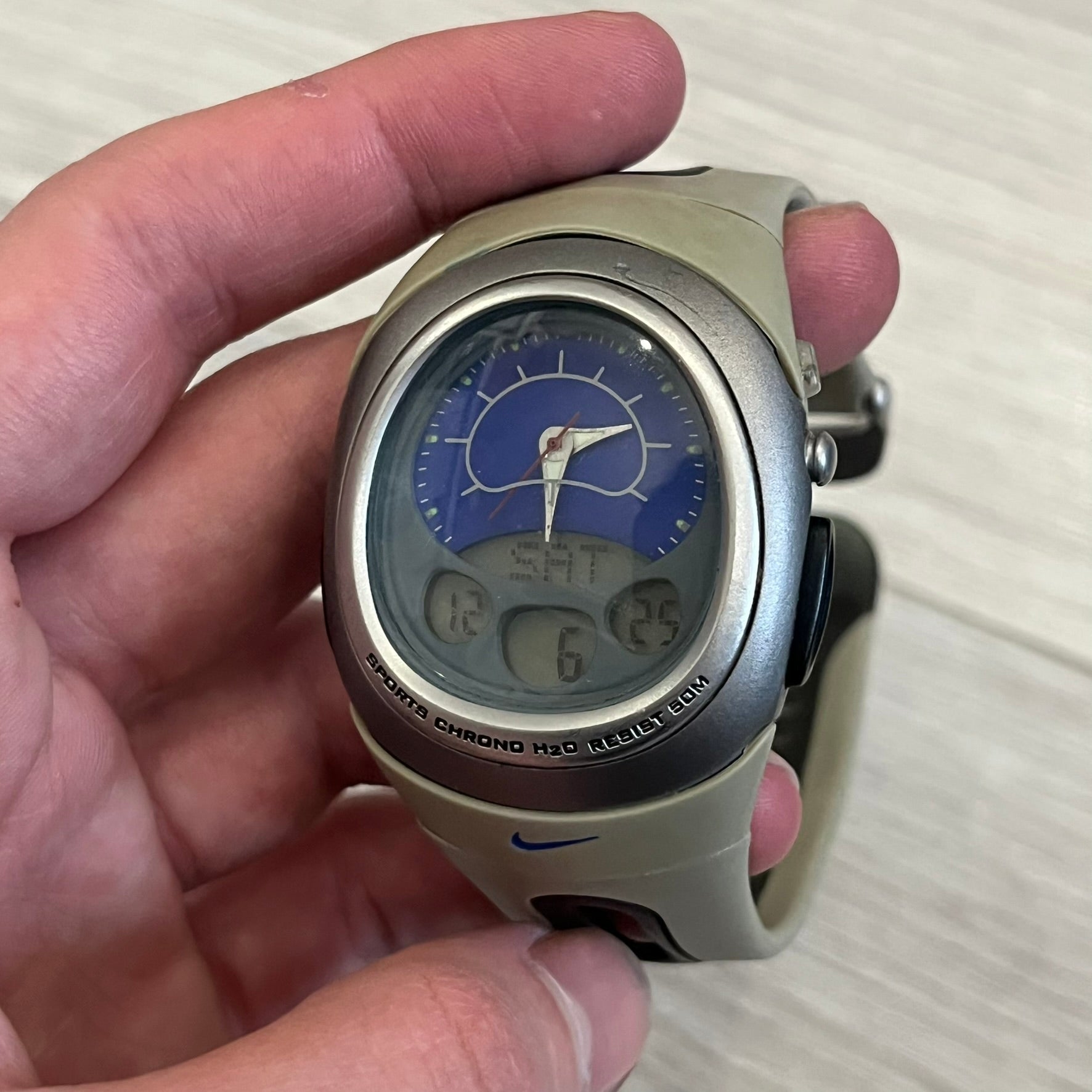 Nike Sports Chrono Cross Training Watch featuring a unique ana-digi design with a Blue Analog face. The display combines a three-hand analog setup with a curved dual-section LCD showing time, day, and mode. Water-resistant up to 50m and equipped with chronograph, timer, alarm, and dual-time functions.