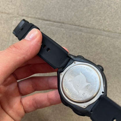 Nike Triax 2000's Super 10 Lap Digital Watch features a black case with a small white Nike Swoosh above the digital display. It has 10-lap memory, four modes, a light-up display, and water resistance. Model WR0005-001. The rubber straps have been replaced with non-original ones.
