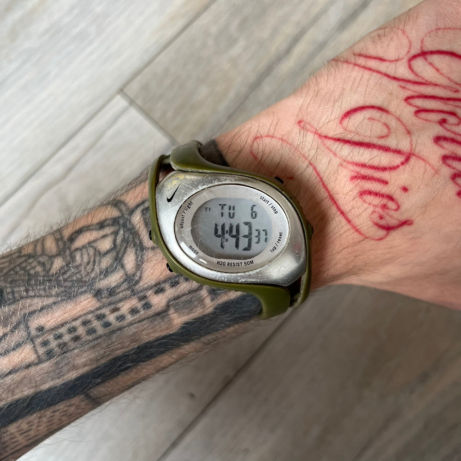 Nike Triax Fly WK0006 Green Digital Watch is a 2000s digital watch featuring a green rubber strap and silver-tone case. It includes multifunction quartz movement, a digital display with backlight functionality, and 50 meter water resistance.