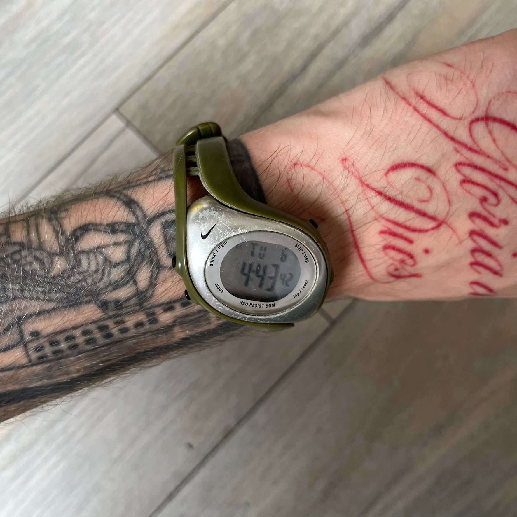 Nike Triax Fly WK0006 Green Digital Watch is a 2000s digital watch featuring a green rubber strap and silver-tone case. It includes multifunction quartz movement, a digital display with backlight functionality, and 50 meter water resistance.