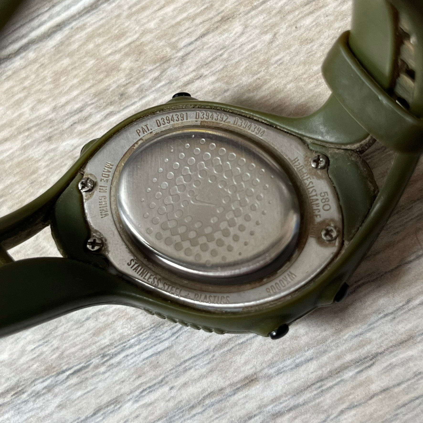 Nike Triax Fly WK0006 Green Digital Watch is a 2000s digital watch featuring a green rubber strap and silver-tone case. It includes multifunction quartz movement, a digital display with backlight functionality, and 50 meter water resistance.