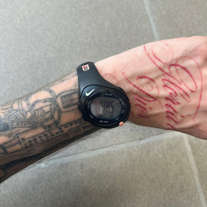 Nike Triax Speed 50 Regular Pink Digital Watch features a black case with four black side buttons and a pink-ish front button for the backlight function. The watch has an white Nike Swoosh on the top of the case, 50-lap memory, multiple modes, and 100m water resistance.