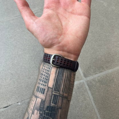 Nike Triax Speed 100 Regular Red Digital Watch features a silver-tone case with four red side buttons and a front button for the backlight function. The watch has an black Nike Swoosh on the top of the case, 100-lap memory, multiple modes, and 100m water resistance. It comes with brown-ish bracelet.
