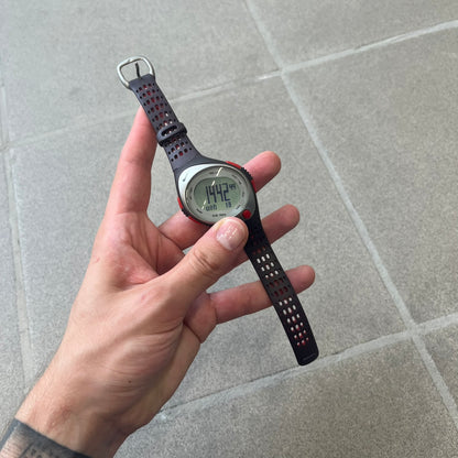 Nike Triax Speed 100 Regular Red Digital Watch features a silver-tone case with four red side buttons and a front button for the backlight function. The watch has an black Nike Swoosh on the top of the case, 100-lap memory, multiple modes, and 100m water resistance. It comes with brown-ish bracelet.
