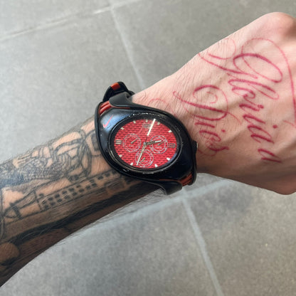 Nike Triax Swift 3i Red WR0091 Analog Watch comes with black &amp; red rubber straps and a black case featuring a red Nike Swoosh. The red metallic dial has a woven pattern, three silver subdials for day, date, and hour and silver hands. Seconds markings are printed on the inner edge of the case and are visible only at an angle. Sport-focused Triax case design with water-resistant construction.