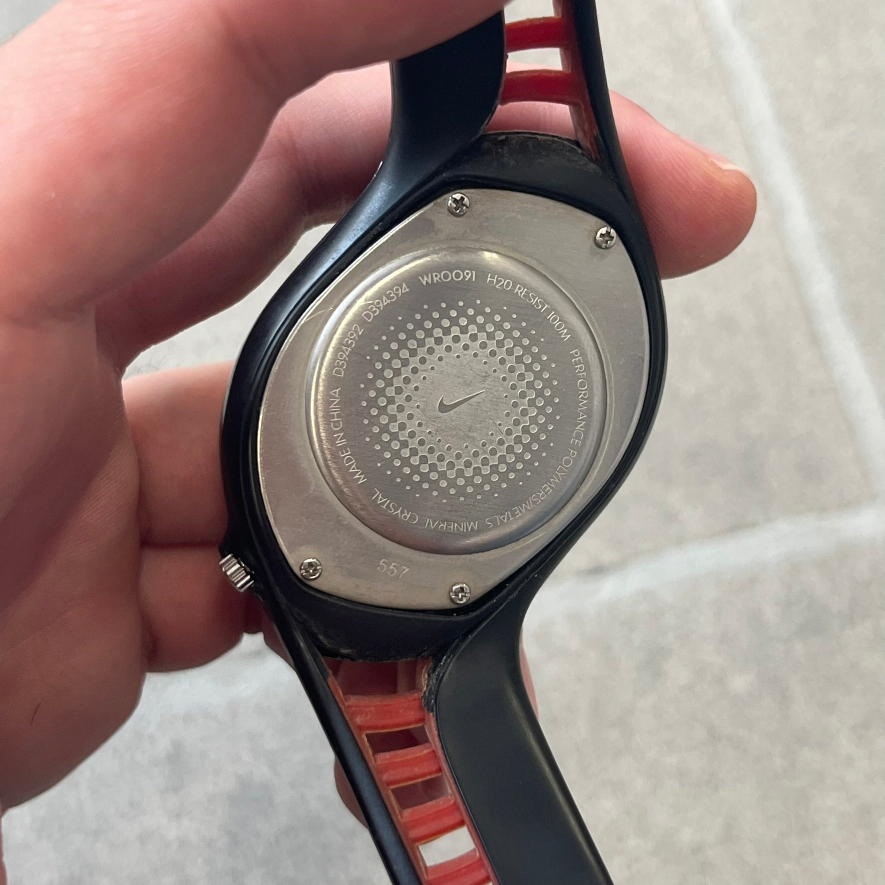 Nike Triax Swift 3i Red WR0091 Analog Watch comes with black &amp; red rubber straps and a black case featuring a red Nike Swoosh. The red metallic dial has a woven pattern, three silver subdials for day, date, and hour and silver hands. Seconds markings are printed on the inner edge of the case and are visible only at an angle. Sport-focused Triax case design with water-resistant construction.