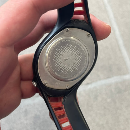Nike Triax Swift 3i Red WR0091 Analog Watch comes with black &amp; red rubber straps and a black case featuring a red Nike Swoosh. The red metallic dial has a woven pattern, three silver subdials for day, date, and hour and silver hands. Seconds markings are printed on the inner edge of the case and are visible only at an angle. Sport-focused Triax case design with water-resistant construction.
