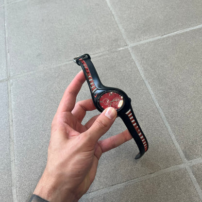 Nike Triax Swift 3i Red WR0091 Analog Watch comes with black &amp; red rubber straps and a black case featuring a red Nike Swoosh. The red metallic dial has a woven pattern, three silver subdials for day, date, and hour and silver hands. Seconds markings are printed on the inner edge of the case and are visible only at an angle. Sport-focused Triax case design with water-resistant construction.