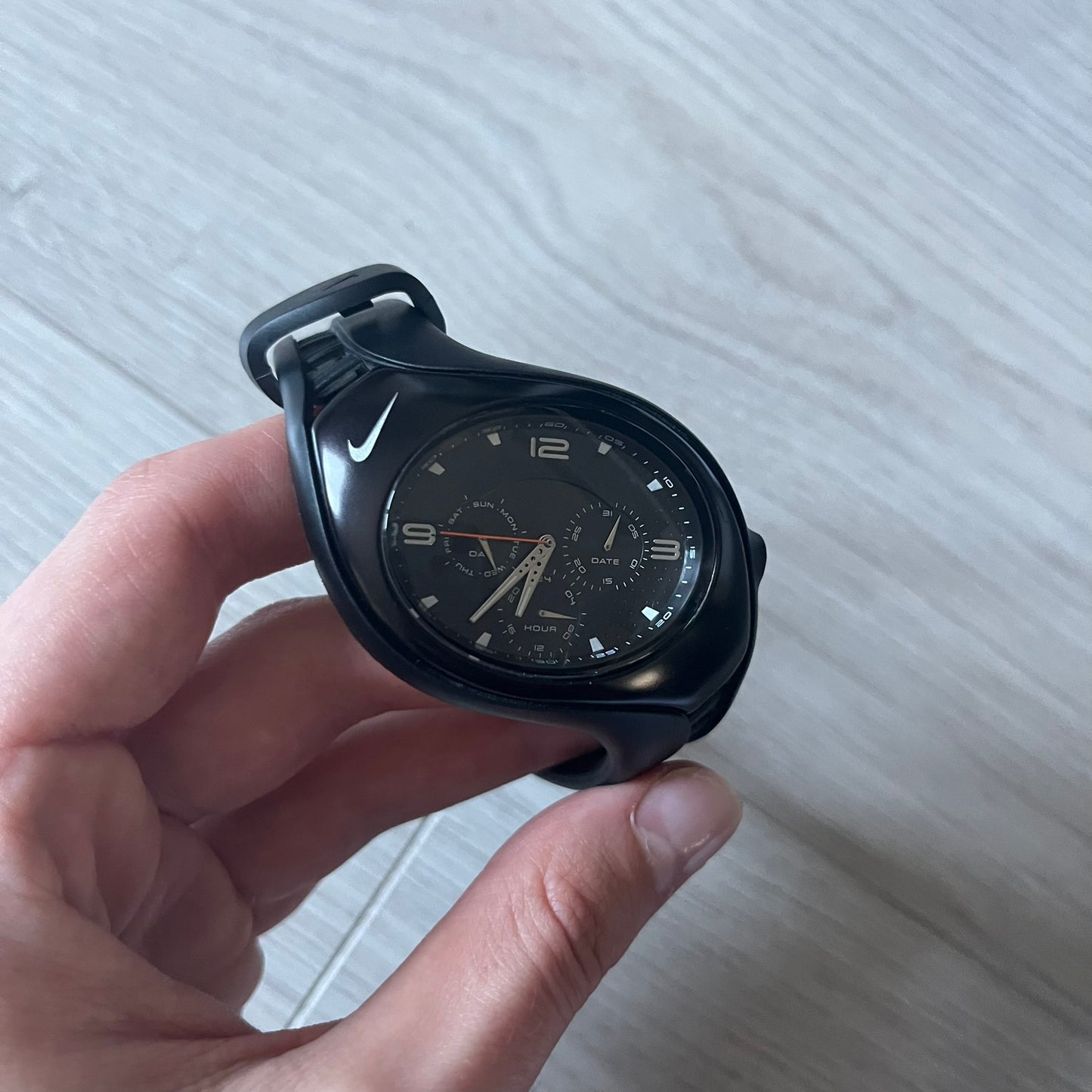 The Nike Triax Swift 3i WR0091 combines futuristic style with functionality. Fully blacked-out construction with silver accents, mineral crystal face and a striking oversized case. Includes day/date display and 100m water resistance. Comes with the original Nike Timing box/papers.
