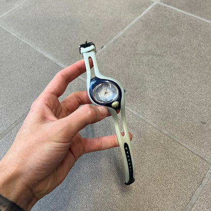Nike Triax Swift FC Porto WR0078 Analog Watch is an analog sports watch featuring a light blue rubber strap integrated into the case design, forming a one-piece construction. The case is metal navy with a Nike Swoosh at the top and a button used to activate the backlight. The dial is blue and white with the FC Porto football team crest, paired with silver hands. It is water resistant up to 100 meters.