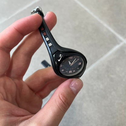 Nike Triax Swift WK0007 Black &amp; Pink Analog Watch features a black rubber strap with matching front case. The black dial has pink hour markers, and silver hands. Small Pink Nike logo sits above the case. Built with stainless steel and metal components, the watch is water resistant up to 50 meters.
