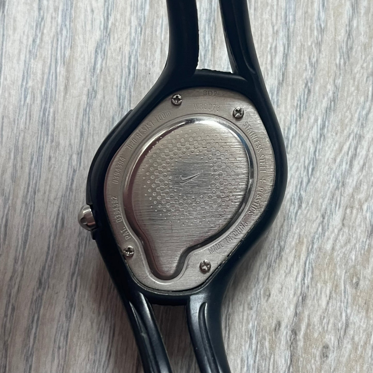 Nike Triax Swift WR0078 analog wristwatch with black rubber straps and a matching rubber outer case. The internal case is silver-tone metal, fitted with a black side button and black Nike Swoosh branding. Features a yellow dotted dial with silver hands and markers. Sport-oriented construction with a clean, functional layout typical of early-2000s Nike Triax models.
