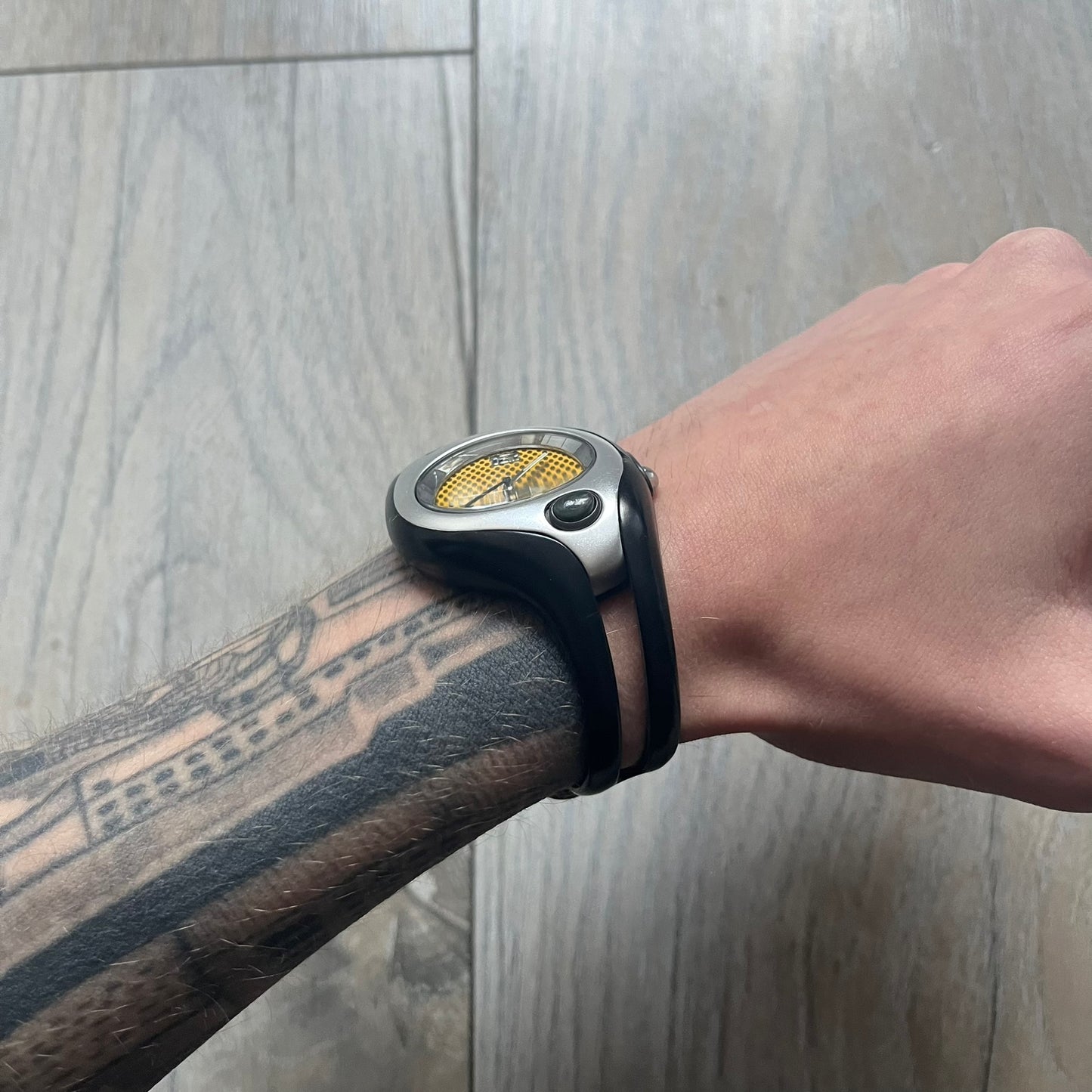 Nike Triax Swift WR0078 analog wristwatch with black rubber straps and a matching rubber outer case. The internal case is silver-tone metal, fitted with a black side button and black Nike Swoosh branding. Features a yellow dotted dial with silver hands and markers. Sport-oriented construction with a clean, functional layout typical of early-2000s Nike Triax models.