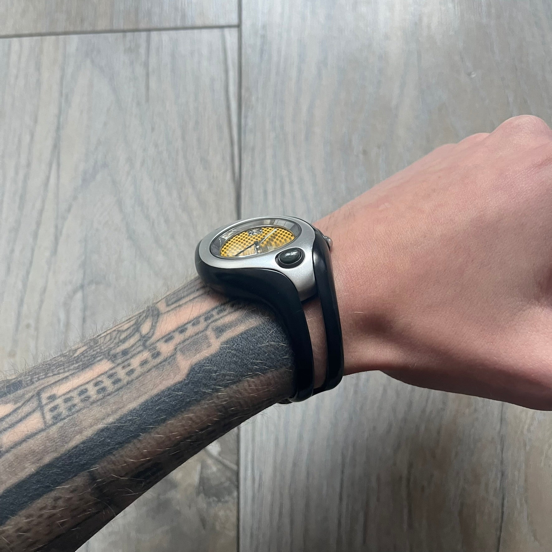 Nike Triax Swift WR0078 analog wristwatch with black rubber straps and a matching rubber outer case. The internal case is silver-tone metal, fitted with a black side button and black Nike Swoosh branding. Features a yellow dotted dial with silver hands and markers. Sport-oriented construction with a clean, functional layout typical of early-2000s Nike Triax models.