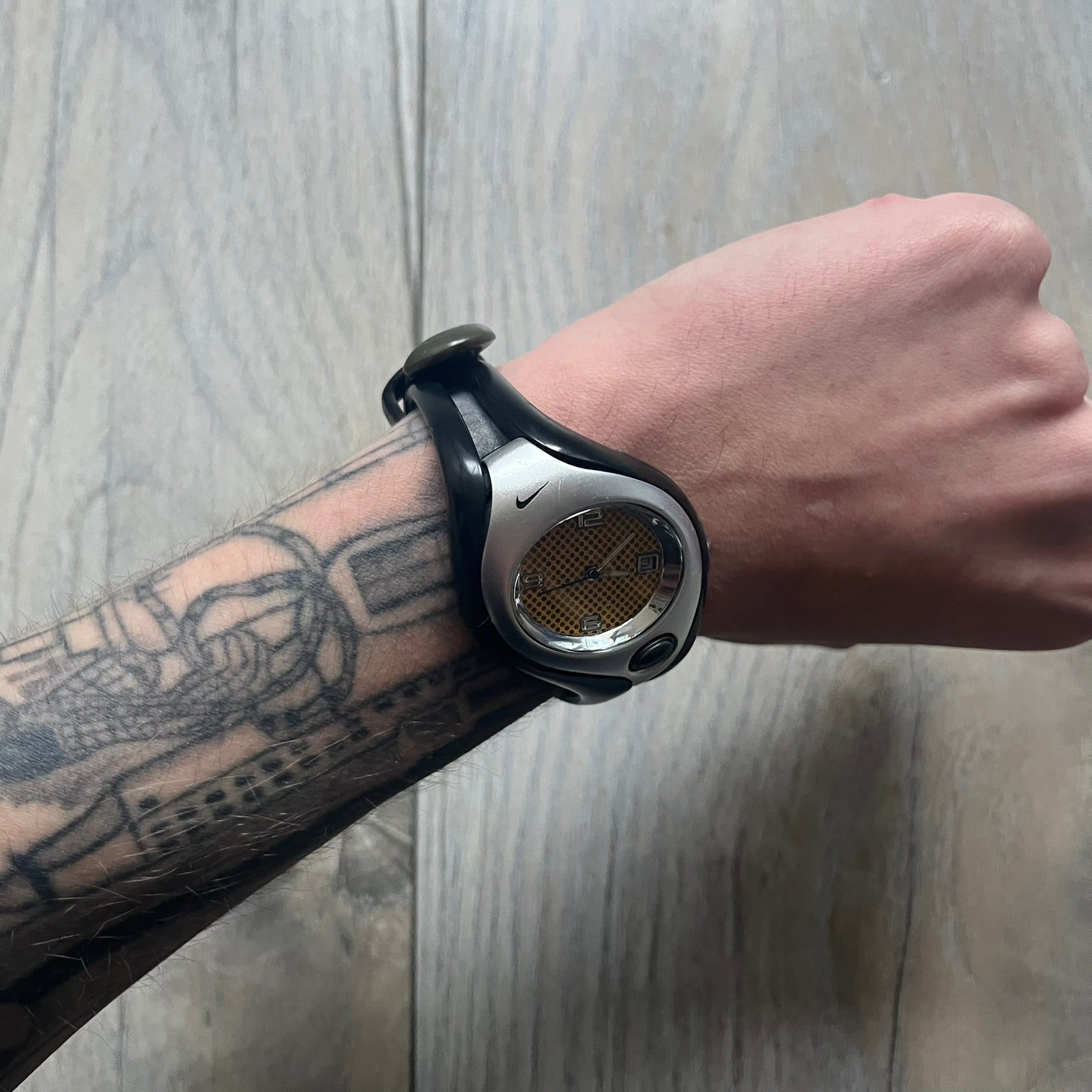Nike Triax Swift WR0078 analog wristwatch with black rubber straps and a matching rubber outer case. The internal case is silver-tone metal, fitted with a black side button and black Nike Swoosh branding. Features a yellow dotted dial with silver hands and markers. Sport-oriented construction with a clean, functional layout typical of early-2000s Nike Triax models.