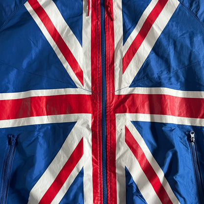 Nike UK Olympics 2008 Split Windbreaker designed by Jarrett Reynolds. Features a blue base with Union Jack-inspired red and white stripes on the front, representing Great Britain. Dual side zippers allow the jacket to be split in half and combined with other pieces from the collection, with a subtle United Kingdom flag inside the pocket.