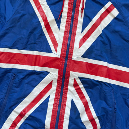 Nike UK Olympics 2008 Split Windbreaker designed by Jarrett Reynolds. Features a blue base with Union Jack-inspired red and white stripes on the front, representing Great Britain. Dual side zippers allow the jacket to be split in half and combined with other pieces from the collection, with a subtle United Kingdom flags inside the pocket.