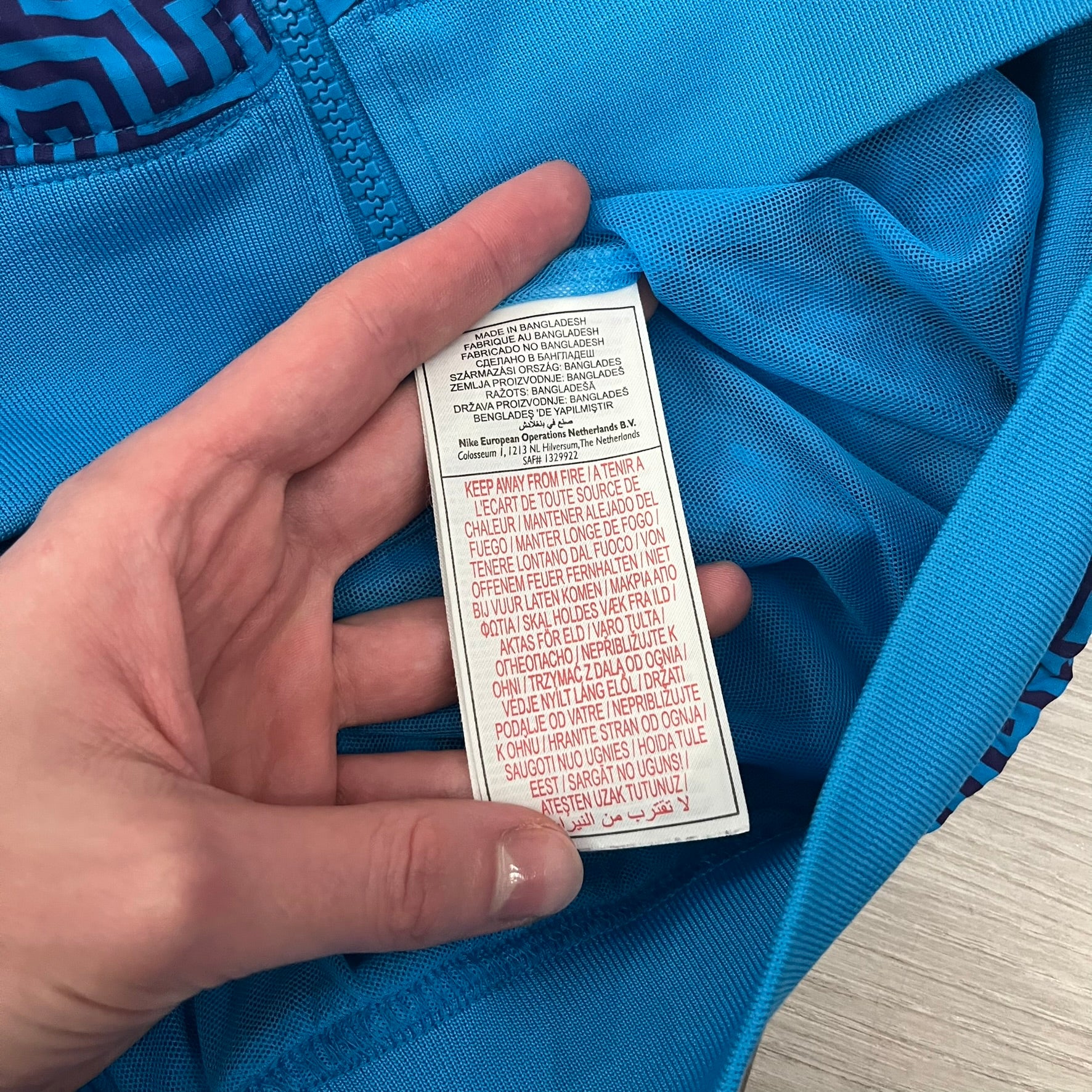 The Nike x Wood Wood “Labyrinth” Split Windbreaker (237110-400) features a full laser blue polyester body with an all-over navy labyrinth print. Designed in Copenhagen, the jacket includes zippers on the front and back allowing it to merge with other compatible models, an embroidered Nike logo and a subtle Wood Wood tag. Inside, a unique printed message from the Wood Wood founders references the jacket’s “Labyrinth” inspiration.