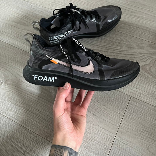The Nike Zoom Fly Off-White Black Silver (AJ4588-001) reimagines Nike’s running silhouette through Virgil Abloh’s distinct Off-White lens. Built with a semi-translucent upper, black midsole, and bold white Swoosh, this 2018 release merges high-fashion design with advanced running technology.