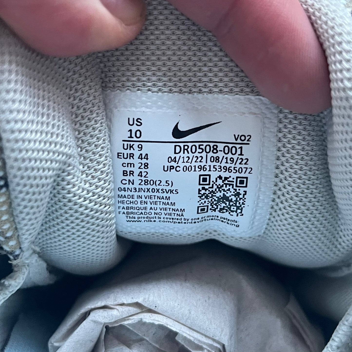 The Nike x NOCTA Hot Step Air Terra “Snakeskin” Light Bone Sneakers feature a low-top silhouette with a textured faux snakeskin upper in Light Bone tones mixed with cobblestone and gum light brown accents. The shoe includes small Swoosh logos on the sides, NOCTA three-star branding on the tongue, perforated quarter panels, and a metallic heel tag with Gore-Tex embossing. Finished with a white midsole housing a visible Air unit at the heel and a gum rubber outsole, style code DR0508-001, colorway Light Bone/