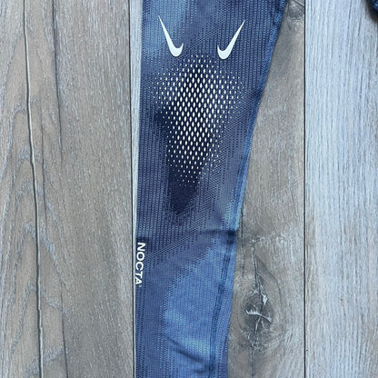 Nike x NOCTA Dri-FIT “Cobalt Bliss” Tights Pants DV3657-479 are men’s slim-fit track tights released on November 8, 2023, as part of the SU2023 collection. The tights feature a Cobalt Bliss blue colorway with light and dark blue (grey-toned) heat map-style patterning throughout, finished with white Nike and NOCTA logos.&nbsp;Constructed with Nike Dri-FIT fabric, they include an elastic waistband with a regular rise and a skinny fit.