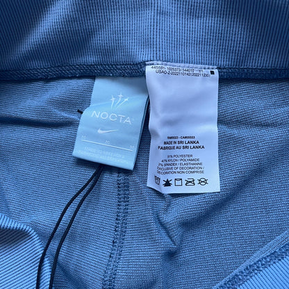 Nike x NOCTA Dri-FIT “Cobalt Bliss” Tights Pants DV3657-479 are men’s slim-fit track tights released on November 8, 2023, as part of the SU2023 collection. The tights feature a Cobalt Bliss blue colorway with light and dark blue (grey-toned) heat map-style patterning throughout, finished with white Nike and NOCTA logos.&nbsp;Constructed with Nike Dri-FIT fabric, they include an elastic waistband with a regular rise and a skinny fit.