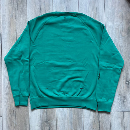 Nike x NOCTA Fleece “Neptune Green” Crewneck Sweatshirt FN8160-370 is a men’s pullover from the Cardinal Stock collection, finished in a Neptune Green/Black colorway. It features a regular fit with a round neckline, long sleeves, elastic cuffs, and an elasticated lower hem.&nbsp;Made from 82% cotton and 18% polyester fleece, the sweatshirt includes a silicone Swoosh logo and signature NOCTA branding, along with a back print, sleeve print, and 3D logo detailing. Made in Vietnam.