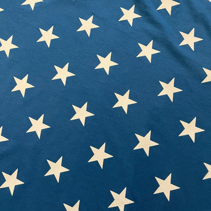 Oakley Crazy Stars Tee in blue with an all-over white star print covering the top two-thirds of the front, back, and sleeves. Features a large Oakley “O” logo on the front. Made from a cotton/polyester blend in El Salvador.