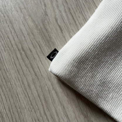 The Oakley Side Ellipse Beige Beanie is made from soft 100% acrylic and features a white tilted O ellipse logo on the side. Designed with a reversible construction for versatile use in changing conditions. A practical and understated piece from Oakley’s performance headwear line.