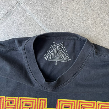 Palace FW18 Mazin Black Longsleeve features a black 100% cotton construction with a Palace logo printed on the chest. The logo is made from a maze-style graphic in yellow and red. Released on November 23, 2018.