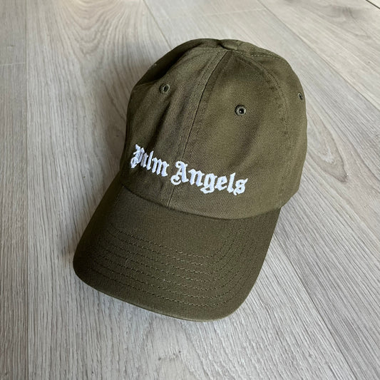 Palm Angels Classic Logo Khaki Baseball Cap made from 100% cotton with white embroidered Palm Angels lettering on both the front and back. Designed with gothic-inspired typography, this cap delivers a clean, minimal look with a streetwear edge.