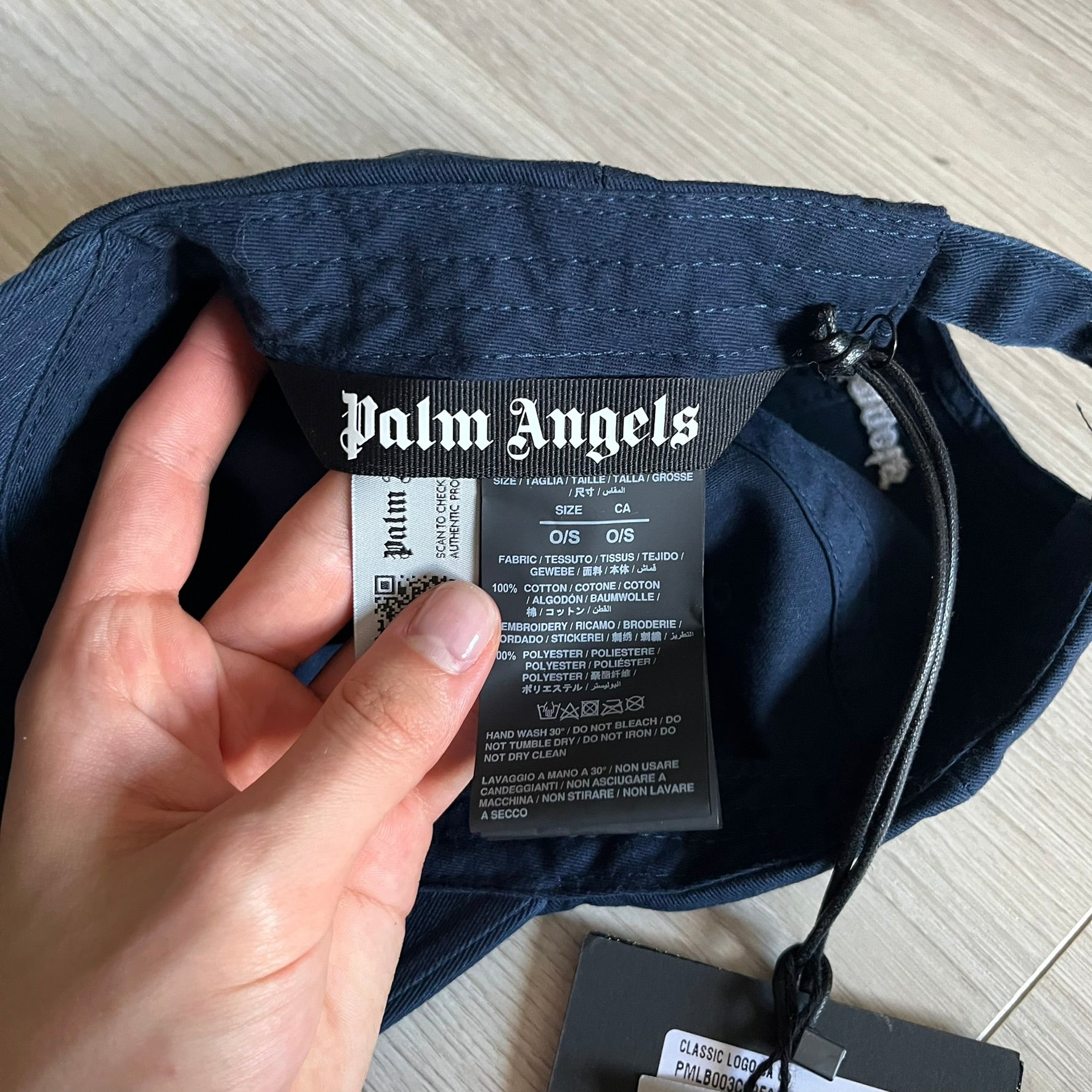 Palm Angels Classic Logo Navy Baseball Cap crafted from 100% cotton. Features white embroidered Palm Angels logos on the front and back in gothic-inspired lettering. A timeless streetwear accessory with a clean navy finish.