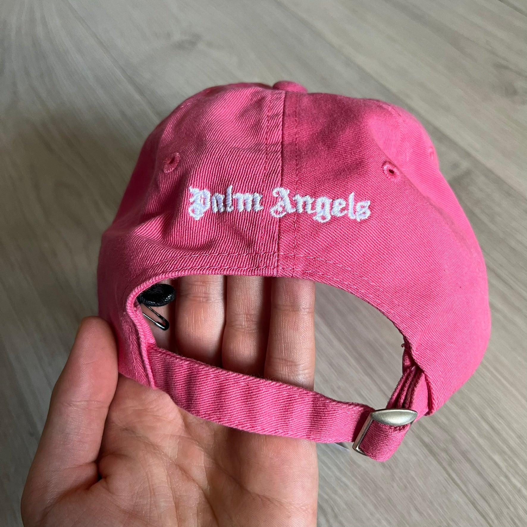 Palm Angels Classic Logo Pink Baseball Cap crafted from 100% cotton. Features white embroidered Palm Angels logos on the front and back in gothic-inspired lettering. A clean, minimal statement piece with a bold color pop.