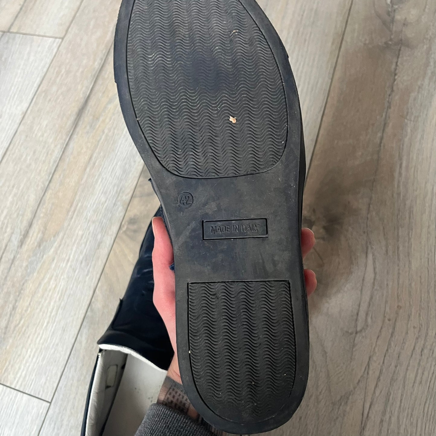 Philipp Plein Navy Skull Slip-Ons are dark navy slip-on sneakers with white interior lining. The front features large raised skull logos, while the sole side displays the Philipp Plein text/logo. Made in Italy, the interior includes an authentic PP tag.