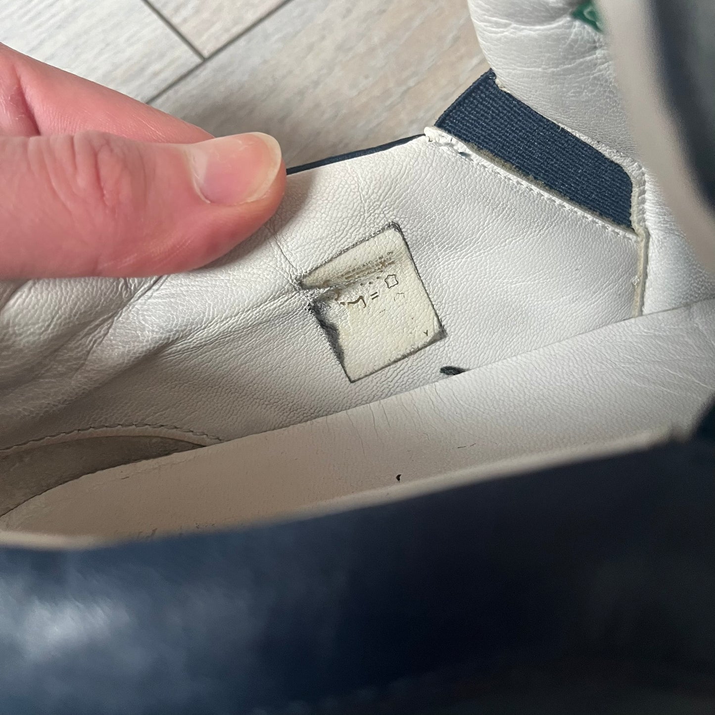 Philipp Plein Navy Skull Slip-Ons are dark navy slip-on sneakers with white interior lining. The front features large raised skull logos, while the sole side displays the Philipp Plein text/logo. Made in Italy, the interior includes an authentic PP tag.