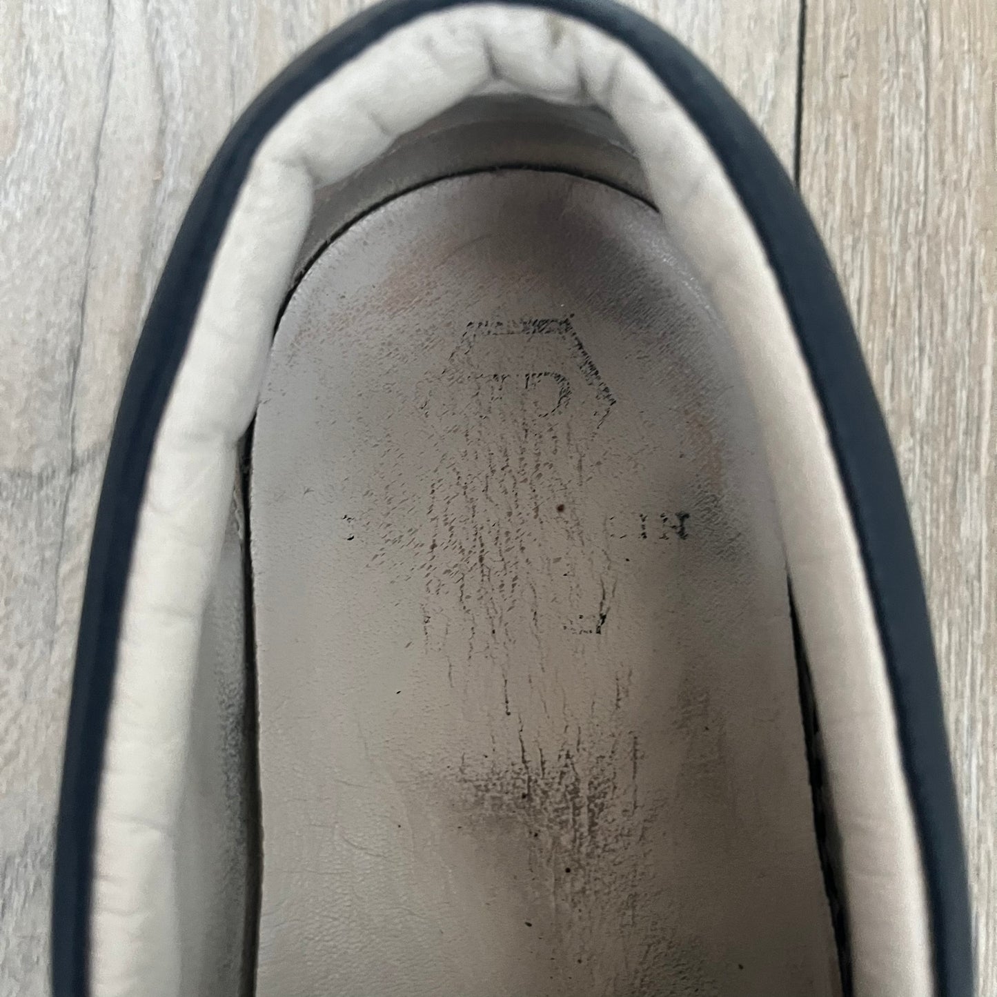 Philipp Plein Navy Skull Slip-Ons are dark navy slip-on sneakers with white interior lining. The front features large raised skull logos, while the sole side displays the Philipp Plein text/logo. Made in Italy, the interior includes an authentic PP tag.