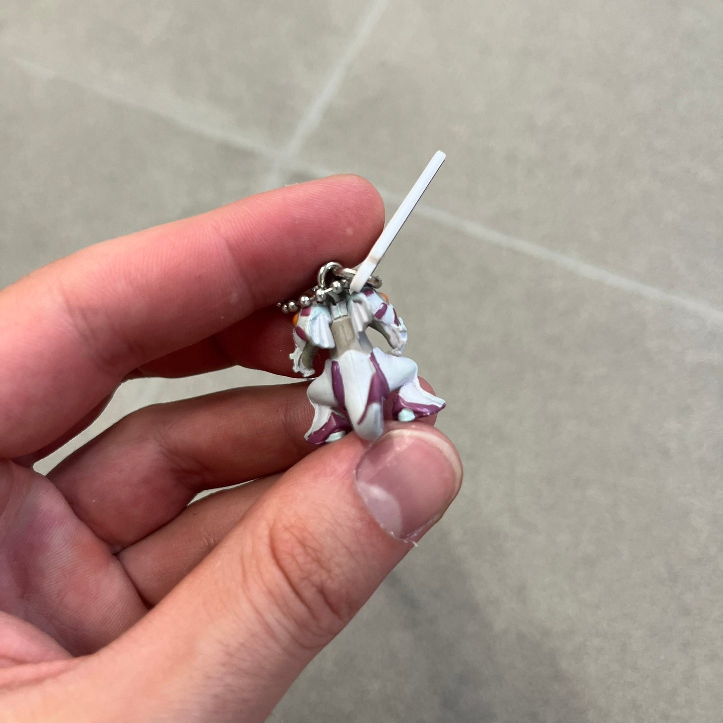Pokémon 2008 Palkia Necklace is a converted Palkia key chain turned into a wearable pendant. It features a small 3D Palkia figure from the Pokémon franchise with an attached Pokémon tag containing licensing details on the back. The pendant design comes from a 2008 key chain release.