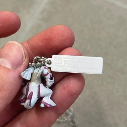 Pokémon 2008 Palkia Necklace is a converted Palkia key chain turned into a wearable pendant. It features a small 3D Palkia figure from the Pokémon franchise with an attached Pokémon tag containing licensing details on the back. The pendant design comes from a 2008 key chain release.