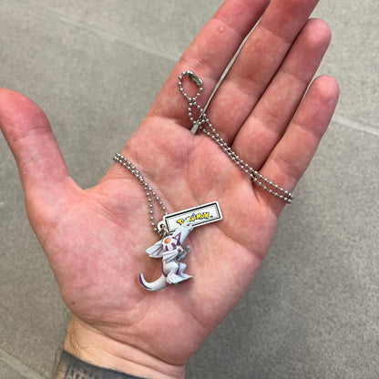 Pokémon 2008 Palkia Necklace is a converted Palkia key chain turned into a wearable pendant. It features a small 3D Palkia figure from the Pokémon franchise with an attached Pokémon tag containing licensing details on the back. The pendant design comes from a 2008 key chain release.