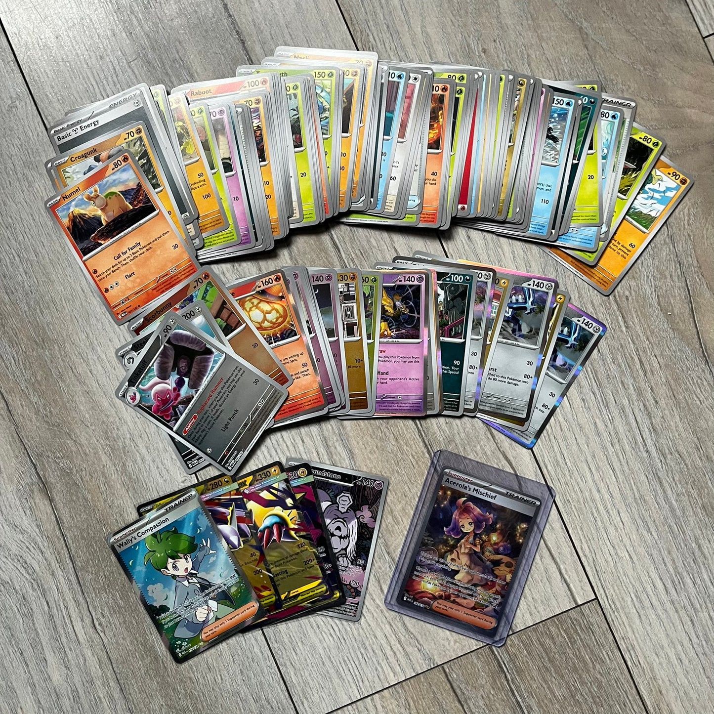 Pokémon TCG: Mega Evolution Phantasmal Flames – 100 Cards includes a collection of 100 trading cards from the Mega Evolution Phantasmal Flames booster series. The set features notable cards such as Acerola’s Mischief and Wally’s Compassion.&nbsp;