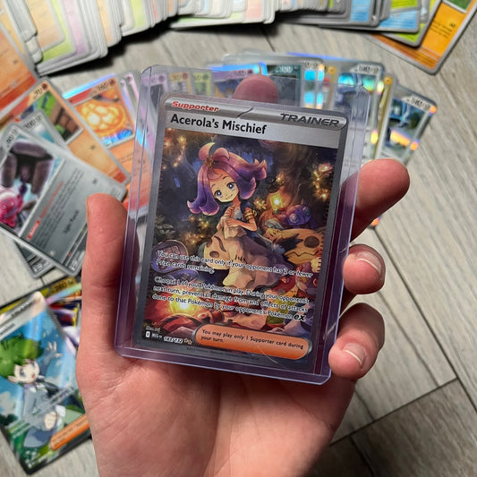 Pokémon TCG: Mega Evolution Phantasmal Flames – 100 Cards includes a collection of 100 trading cards from the Mega Evolution Phantasmal Flames booster series. The set features notable cards such as Acerola’s Mischief and Wally’s Compassion.&nbsp;